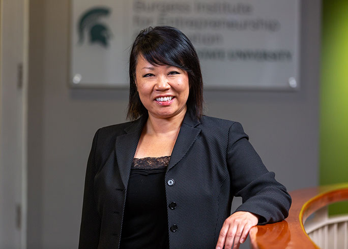 Lori Fischer, director of operations, posing in black power suit