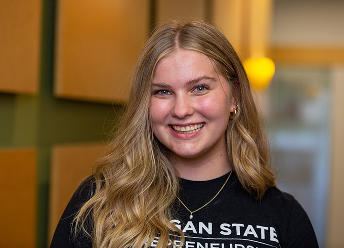 Aubrey Haase, events and engagement coordinator, poses in MSU Entrepreneurship attire